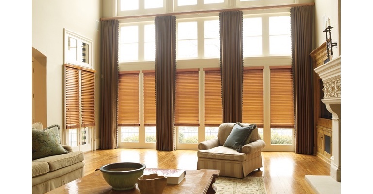 Indianapolis great room with wooden blinds and full-length drapes.